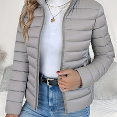 Women's lightweight quilted puffer coat with stand collar and zip-up front, designed by Christine Brewer.
