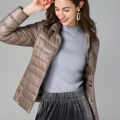 Women's lightweight quilted puffer coat with stand collar and zip-up front by Christine Brewer, suitable for chilly weather.