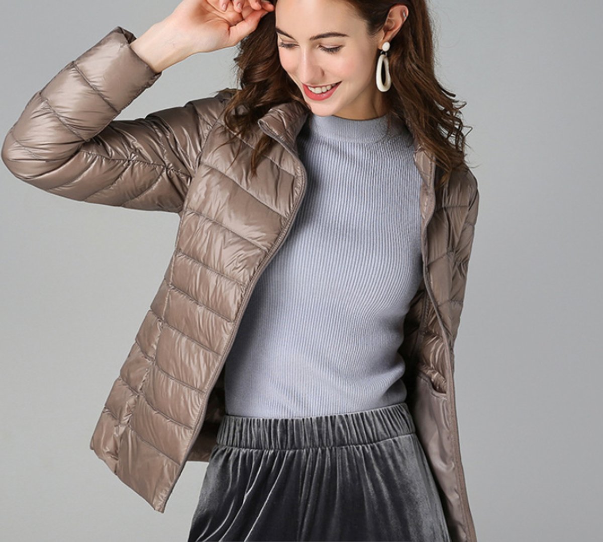 Women's lightweight quilted puffer coat with stand collar and zip-up front by Christine Brewer, suitable for chilly weather.