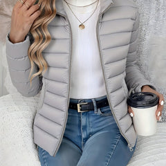 Women's lightweight quilted puffer coat by Christine Brewer with stand collar and front zip-up closure.