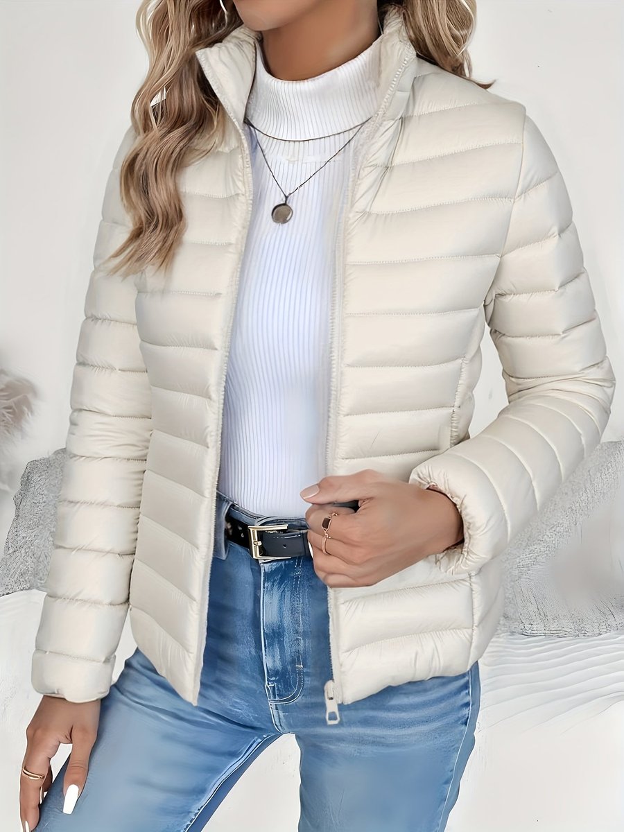 Women's lightweight quilted puffer coat with stand collar and zip-up front, designed by Christine Brewer.