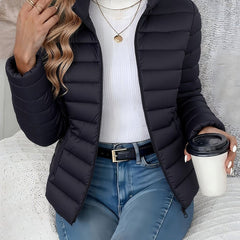 Women's lightweight quilted puffer coat by Christine Brewer with stand collar and front zip-up closure.