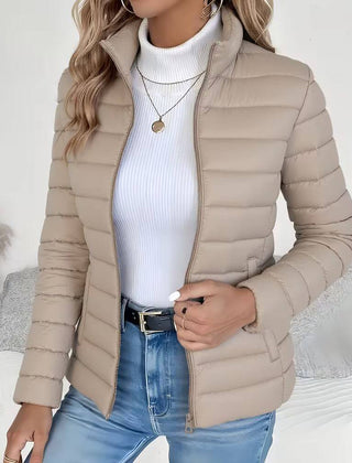 Women's lightweight quilted puffer jacket with stand collar by Christine Brewer, shown in a stylish and cozy design.