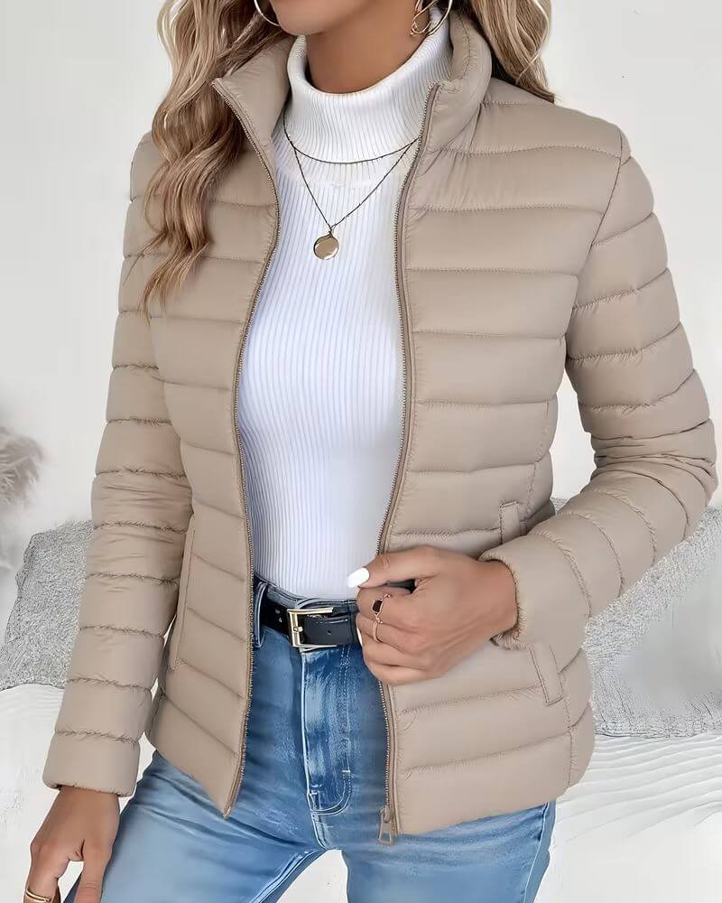 Women's lightweight quilted puffer jacket with stand collar by Christine Brewer, shown in a stylish and cozy design.