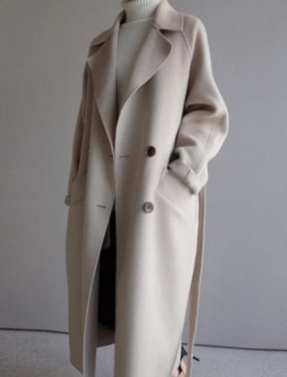Women's long double-breasted wool-blend trench coat in a longline style by Christine Brewer, shown on a model.