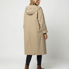 Women's Rosie waterproof windproof hooded trench coat by Christine Brewer, shown in a long, stylish, rain-resistant design.