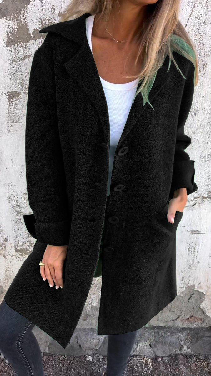 Women's longline button-up coat with lapel collar in oversized fit by Christine Brewer, showcasing stylish, warm outerwear.