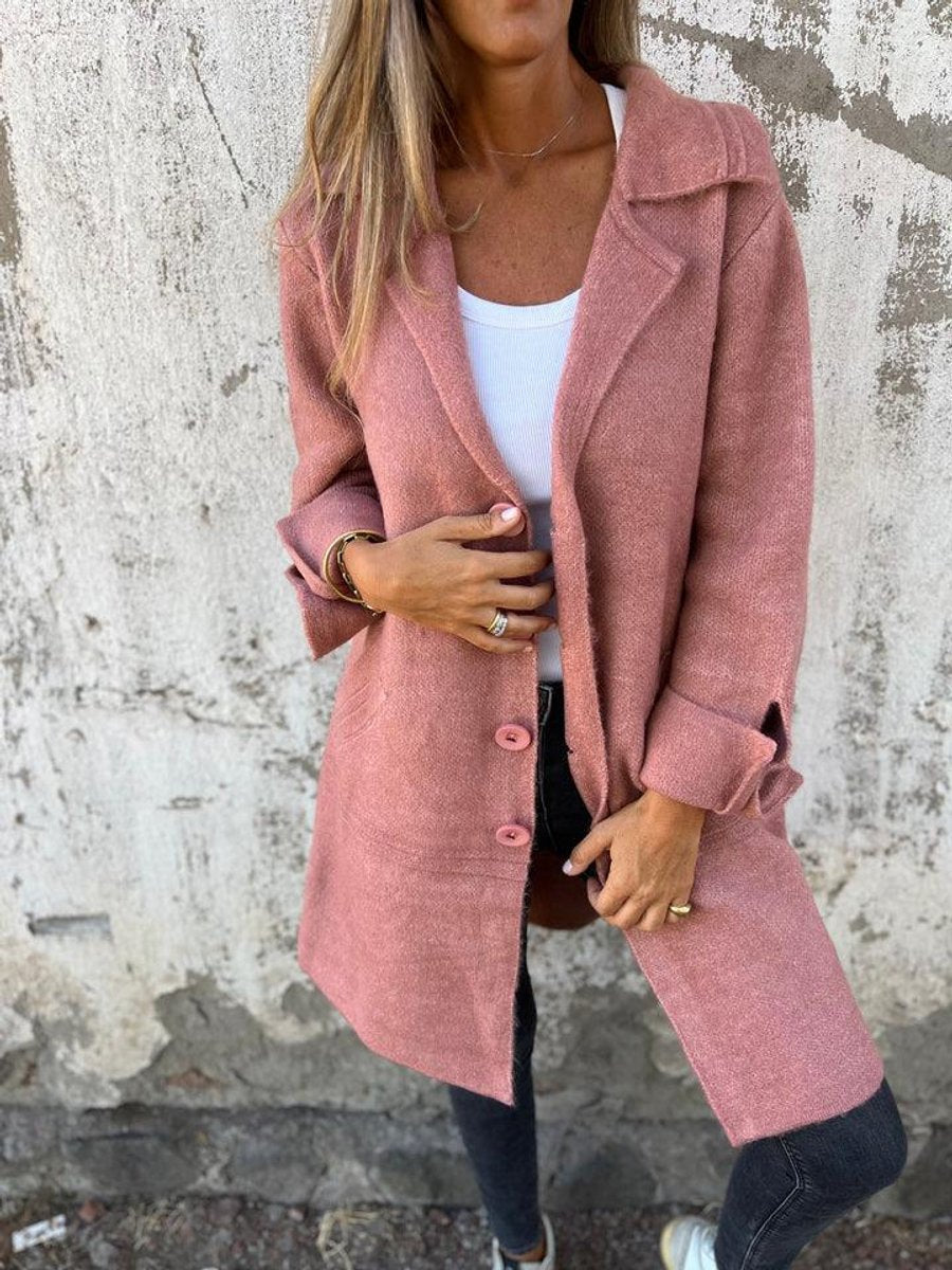 Women's longline button-up coat with lapel collar and oversized fit by Christine Brewer, shown with front view and tailored details.
