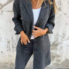 Women's longline button-up coat with lapel collar in oversized fit by Christine Brewer, shown hanging on a hanger.