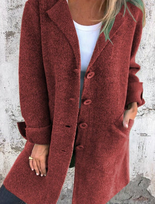 Women's longline button-up coat with lapel collar and oversized fit by Christine Brewer, shown on a model.