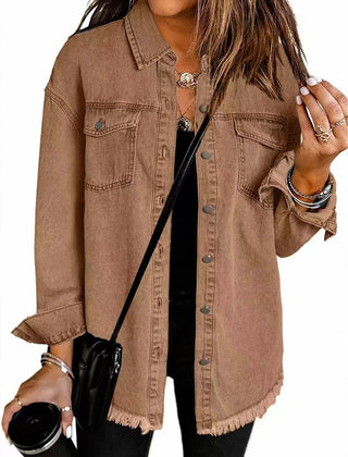 Olivia women's oversized black denim jacket by Christine Brewer with longline style and frayed hem, styled on a model.