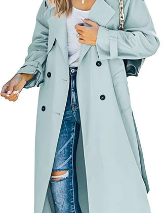 Women’s oversized double-breasted belted longline trench coat by Christine Brewer, shown on a model, in classic beige.
