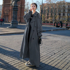 Emily women's oversized double-breasted longline trench coat by Christine Brewer, shown in a stylish, beige fabric with wide lapels.