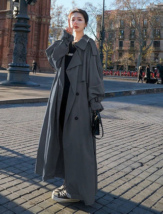 Emily women's oversized double-breasted longline trench coat by Christine Brewer, shown in a stylish, beige fabric with wide lapels.