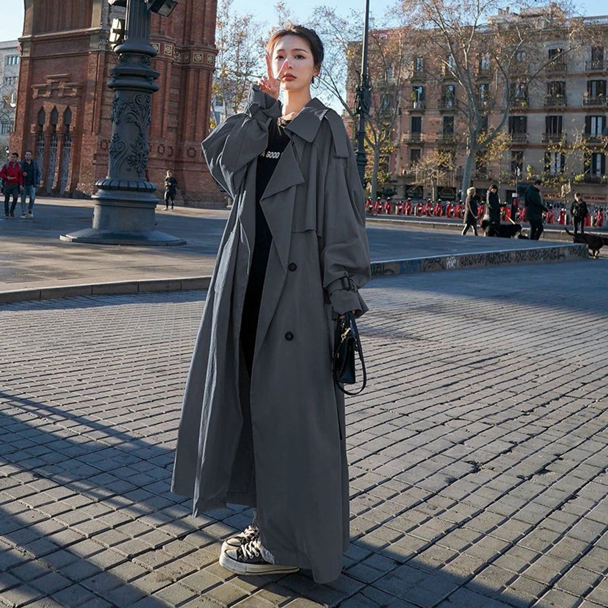 Emily women's oversized double-breasted longline trench coat by Christine Brewer, shown in a stylish, beige fabric with wide lapels.