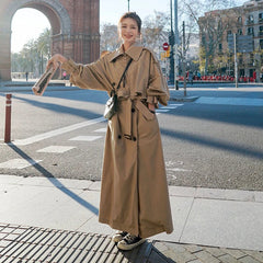 Emily women's oversized double-breasted longline trench coat by Christine Brewer, shown in a neutral color with wide lapels and belt.