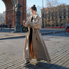 Emily women's oversized double-breasted longline trench coat in classic beige, featuring wide lapels and belted waist.