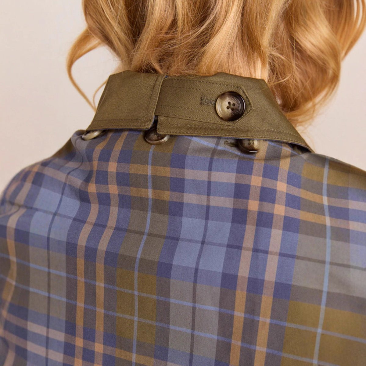 Women's oversized double-breasted plaid-lined trench coat by Christine Brewer, shown on a model, featuring classic style and warm lining.