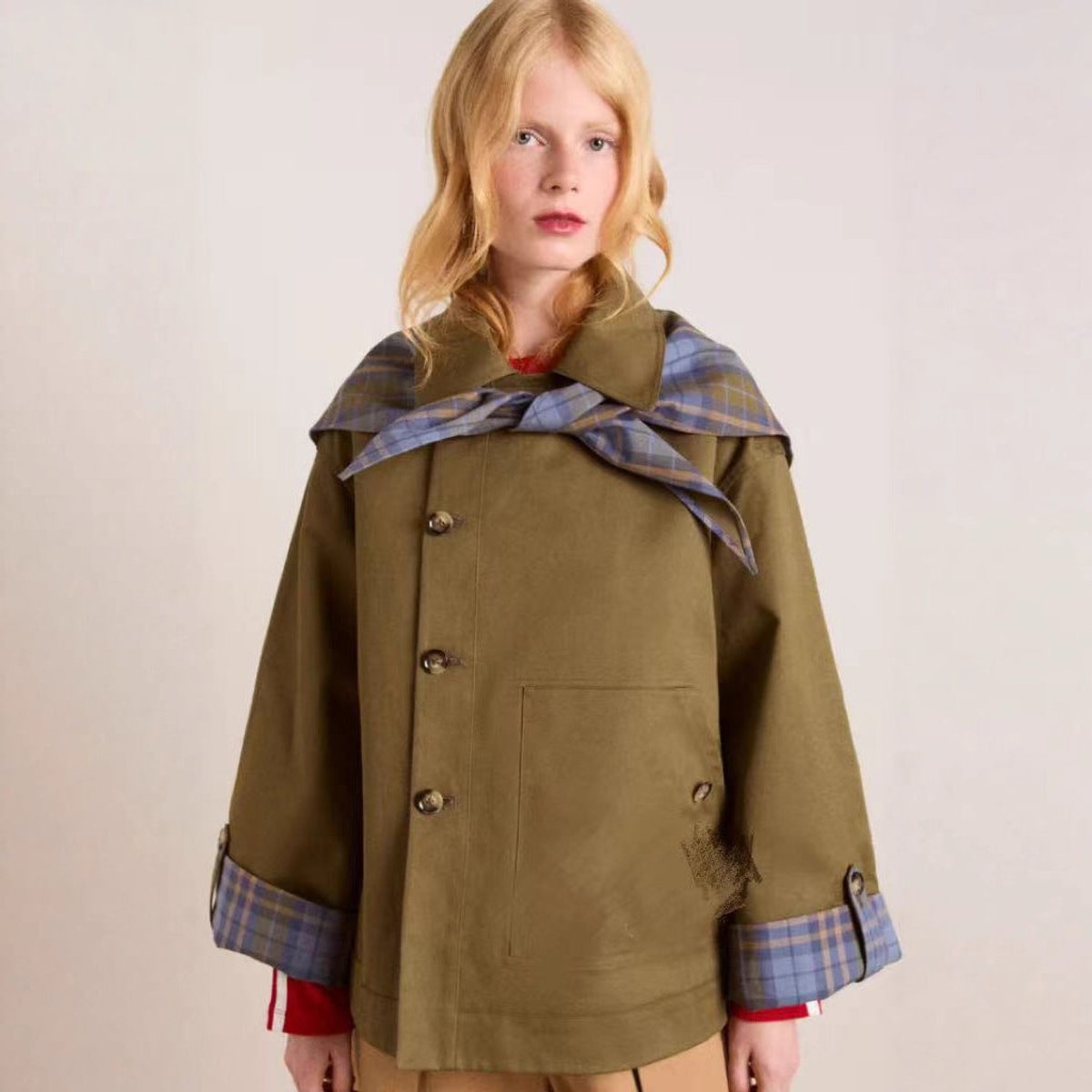 Women's oversized double-breasted trench coat by Christine Brewer with tartan-lined collar and classic silhouette.