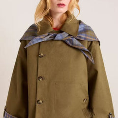 Women's oversized double-breasted trench coat by Christine Brewer with tartan-lined collar and classic trench coat design.