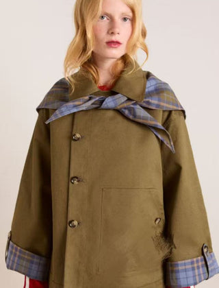 Women's oversized double-breasted trench coat by Christine Brewer with tartan-lined collar and classic trench coat design.