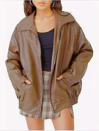 Women's oversized faux leather bomber jacket by Christine Brewer with front zip-up closure, shown in black on a model.