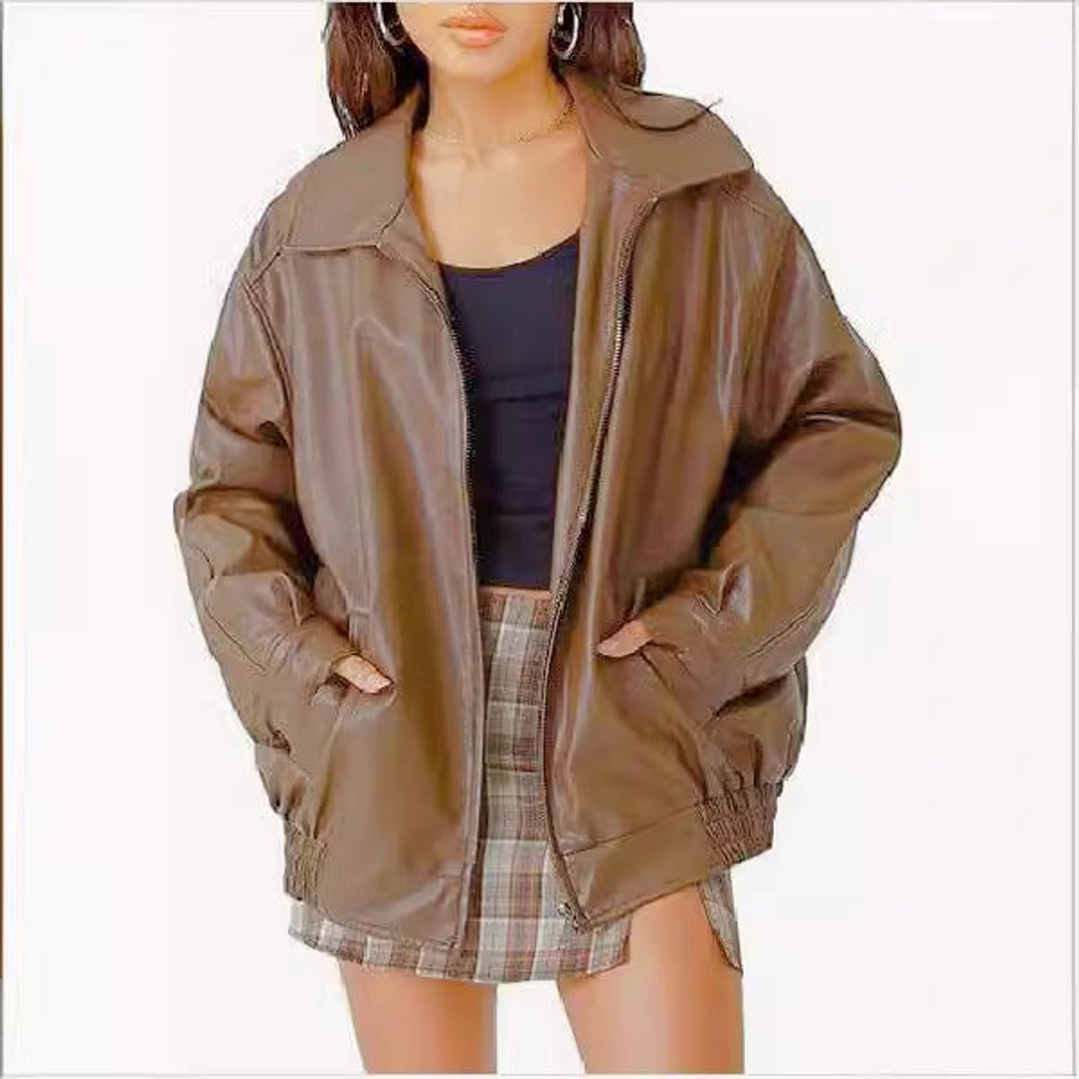 Women's oversized faux leather bomber jacket by Christine Brewer with front zip-up closure, shown in black on a model.