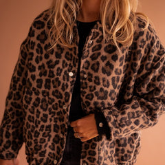 Women's oversized leopard print quilted jacket with snap buttons by Christine Brewer, featuring bold animal print and cozy design.