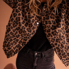 Women's oversized leopard print quilted jacket with snap buttons by Christine Brewer, featuring bold animal print design.