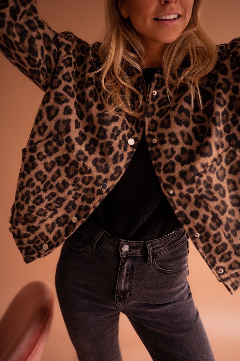 Women's oversized leopard print quilted jacket with snap buttons by Christine Brewer, featuring bold animal print design.