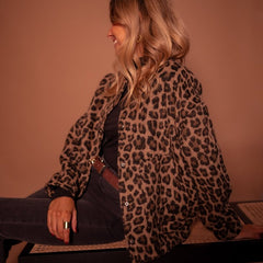Women's oversized leopard print quilted jacket with snap buttons, featuring animal print design by Christine Brewer.