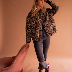 Women's oversized leopard print quilted jacket by Christine Brewer with snap buttons, featuring a bold animal print design.