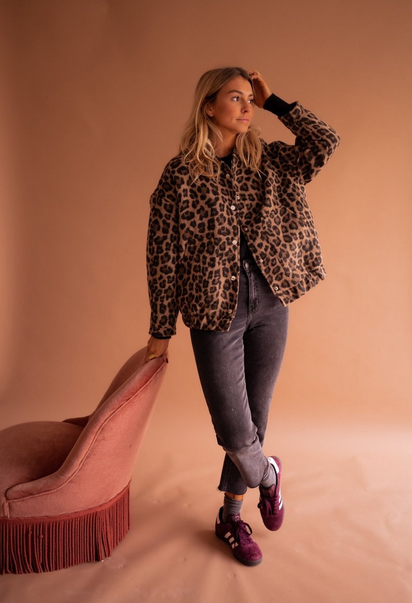 Women's oversized leopard print quilted jacket by Christine Brewer with snap buttons, featuring a bold animal print design.