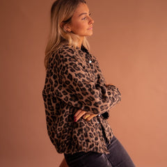Women's oversized leopard print quilted jacket with snap buttons by Christine Brewer, featuring animal print design and cozy quilted fabric.