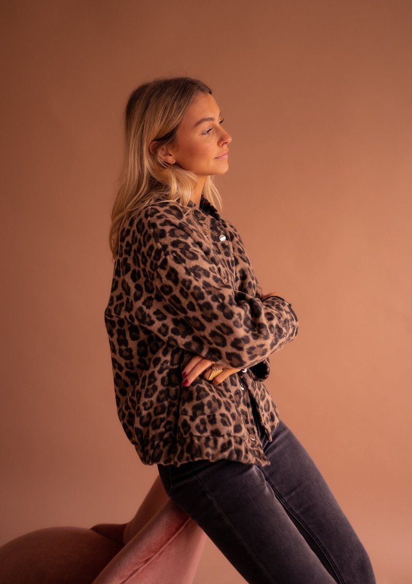 Women's oversized leopard print quilted jacket with snap buttons by Christine Brewer, featuring animal print design and cozy quilted fabric.