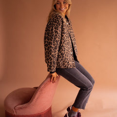 Women's oversized leopard print quilted jacket with snap buttons by Christine Brewer, featuring bold animal print and cozy quilted design.