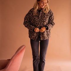 Women's oversized leopard print quilted jacket with snap buttons by Christine Brewer, featuring bold animal print and cozy quilted design.