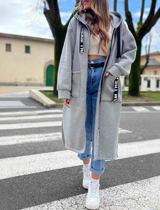 Women's oversized long hooded zip-up coat by Christine Brewer, featuring a relaxed fit and cozy hooded design.