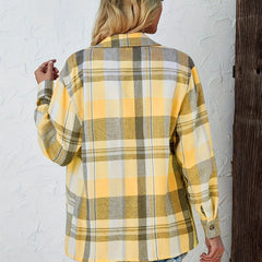 Women’s oversized plaid flannel long sleeve button-up shirt by Christine Brewer, featuring a classic red and black checkered pattern.