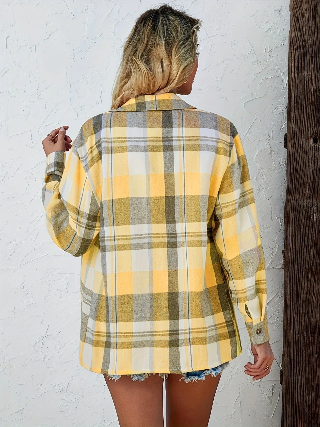 Women’s oversized plaid flannel long sleeve button-up shirt by Christine Brewer, featuring a classic red and black checkered pattern.