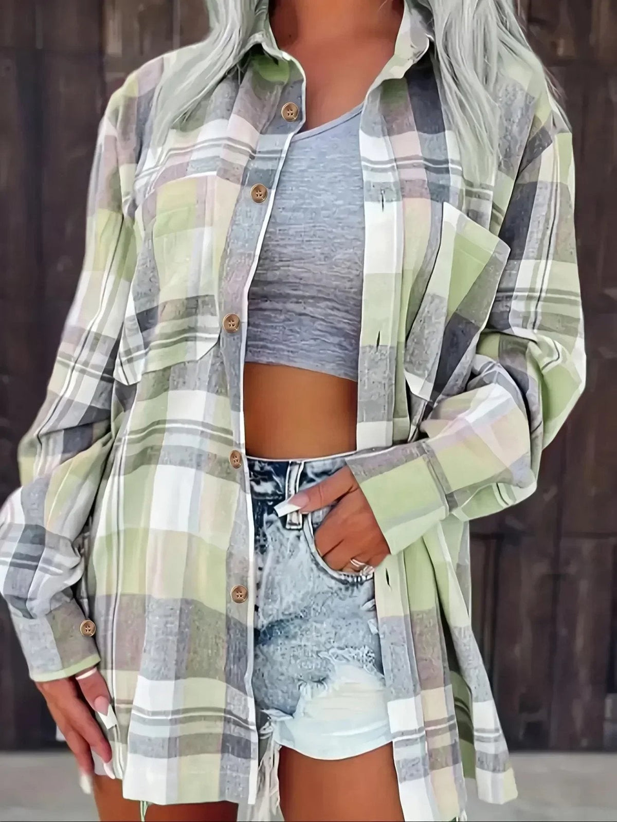 Women's oversized plaid flannel long sleeve button-up shirt by Christine Brewer, featuring a classic checkered pattern and relaxed fit.