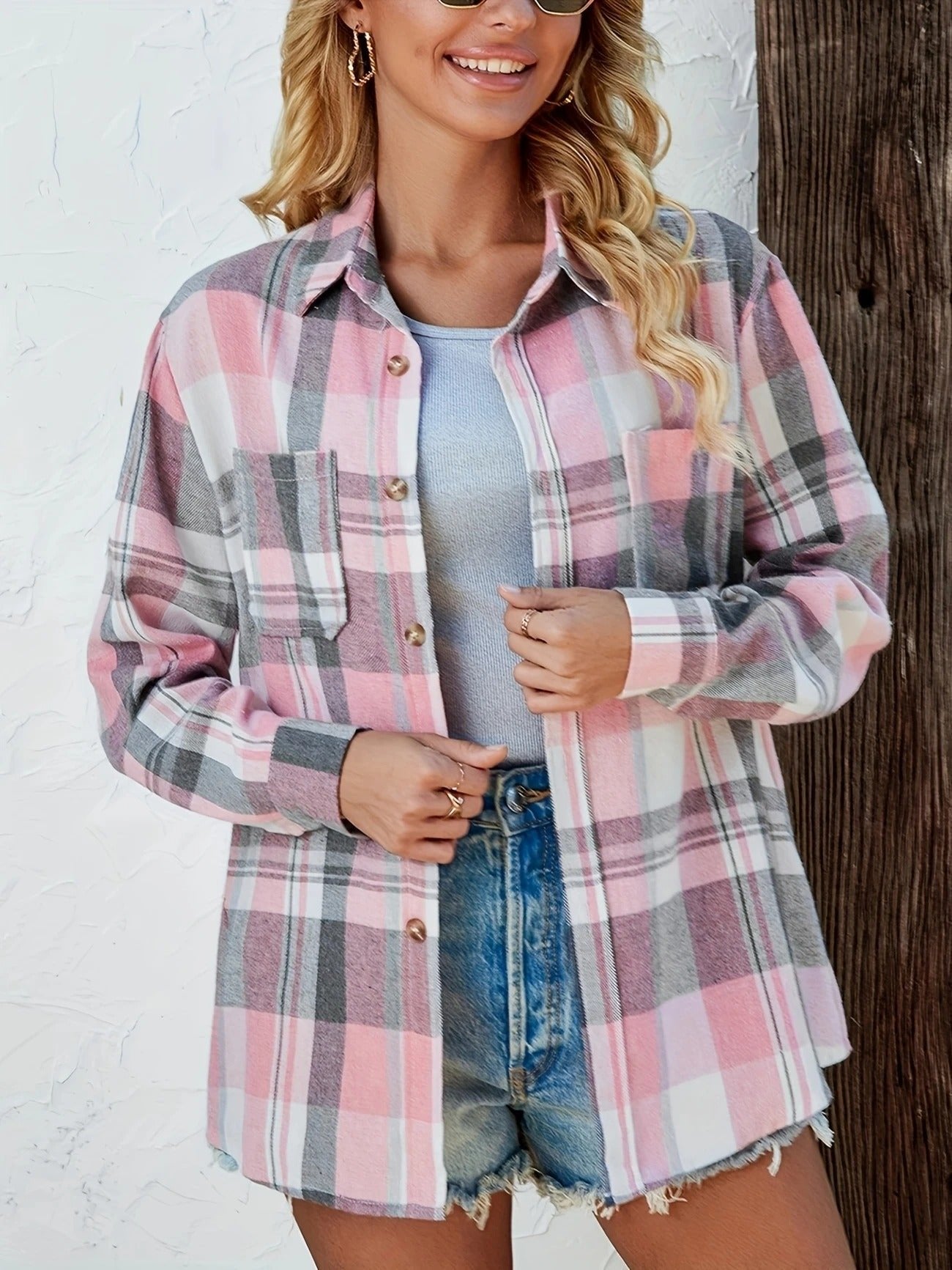 Women’s oversized plaid flannel long sleeve button-up shirt by Christine Brewer, featuring a classic red and black checkered pattern.
