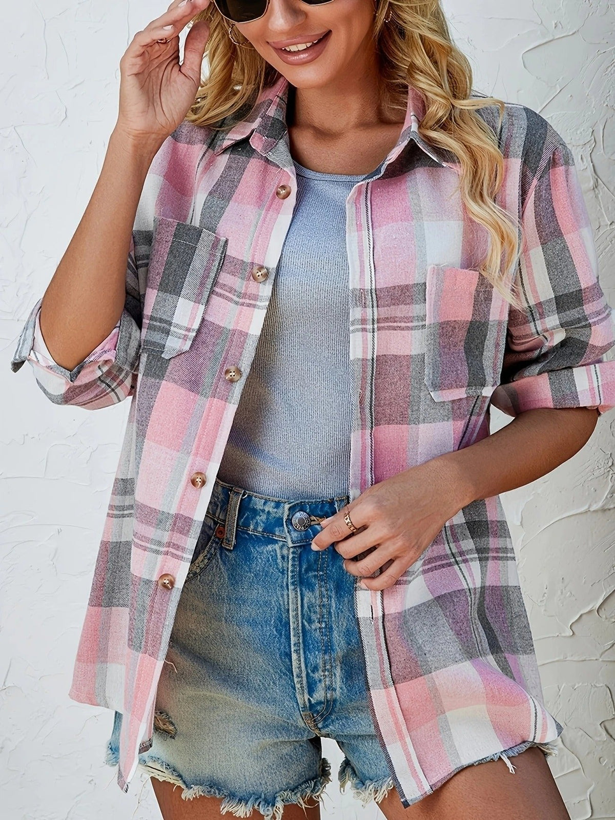 Women's oversized plaid flannel long sleeve button-up shirt by Christine Brewer, featuring a classic checkered pattern and relaxed fit.