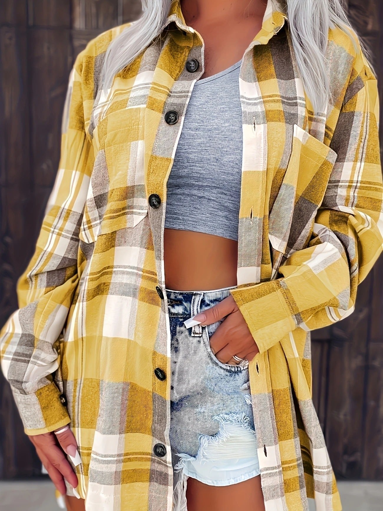 Women’s oversized plaid flannel long sleeve button-up shirt by Christine Brewer, featuring classic checkered pattern in warm tones.