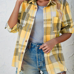 Women's oversized plaid flannel shirt by Christine Brewer featuring long sleeves and button-up front, in a classic plaid pattern.
