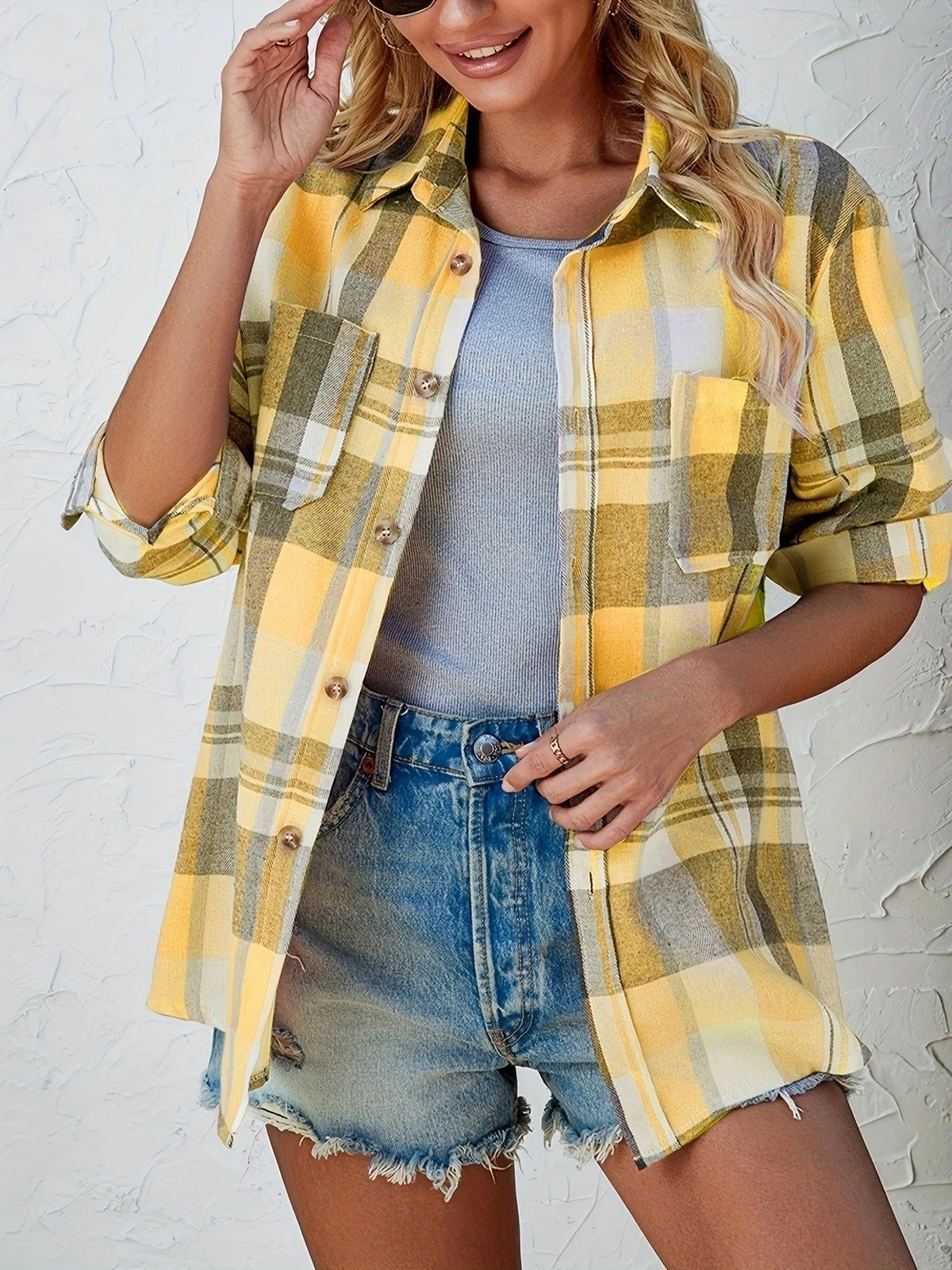Women's oversized plaid flannel shirt by Christine Brewer featuring long sleeves and button-up front, in a classic plaid pattern.