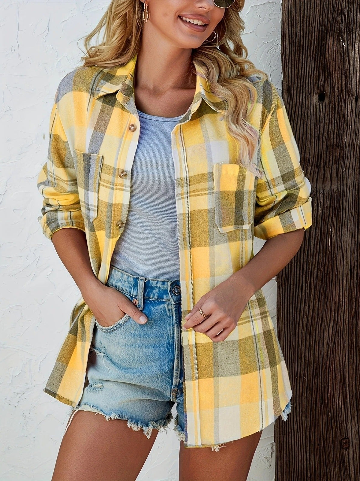 Women's oversized plaid flannel long sleeve button-up shirt by Christine Brewer, featuring a relaxed fit and classic plaid pattern.