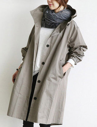 Women's oversized water-resistant trench coat with button front in beige, stylish and functional outerwear by Christine Brewer.