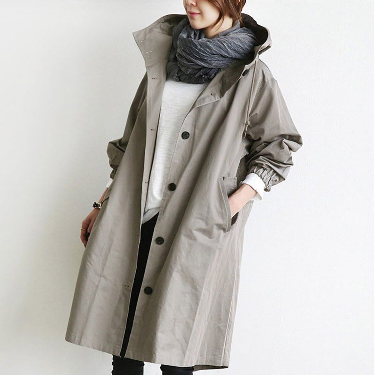 Women's oversized water-resistant trench coat with button front in beige, stylish and functional outerwear by Christine Brewer.