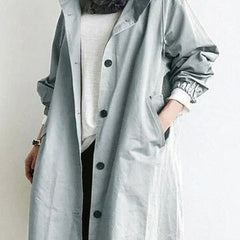 Women's oversized water-resistant trench coat by Christine Brewer featuring a button-front design and classic trench style.